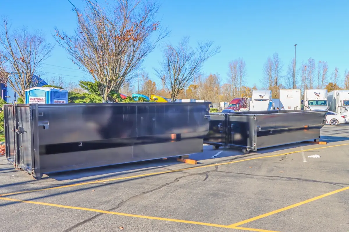 Professional dumpster rental service with roll-off container on residential driveway in Eatontown